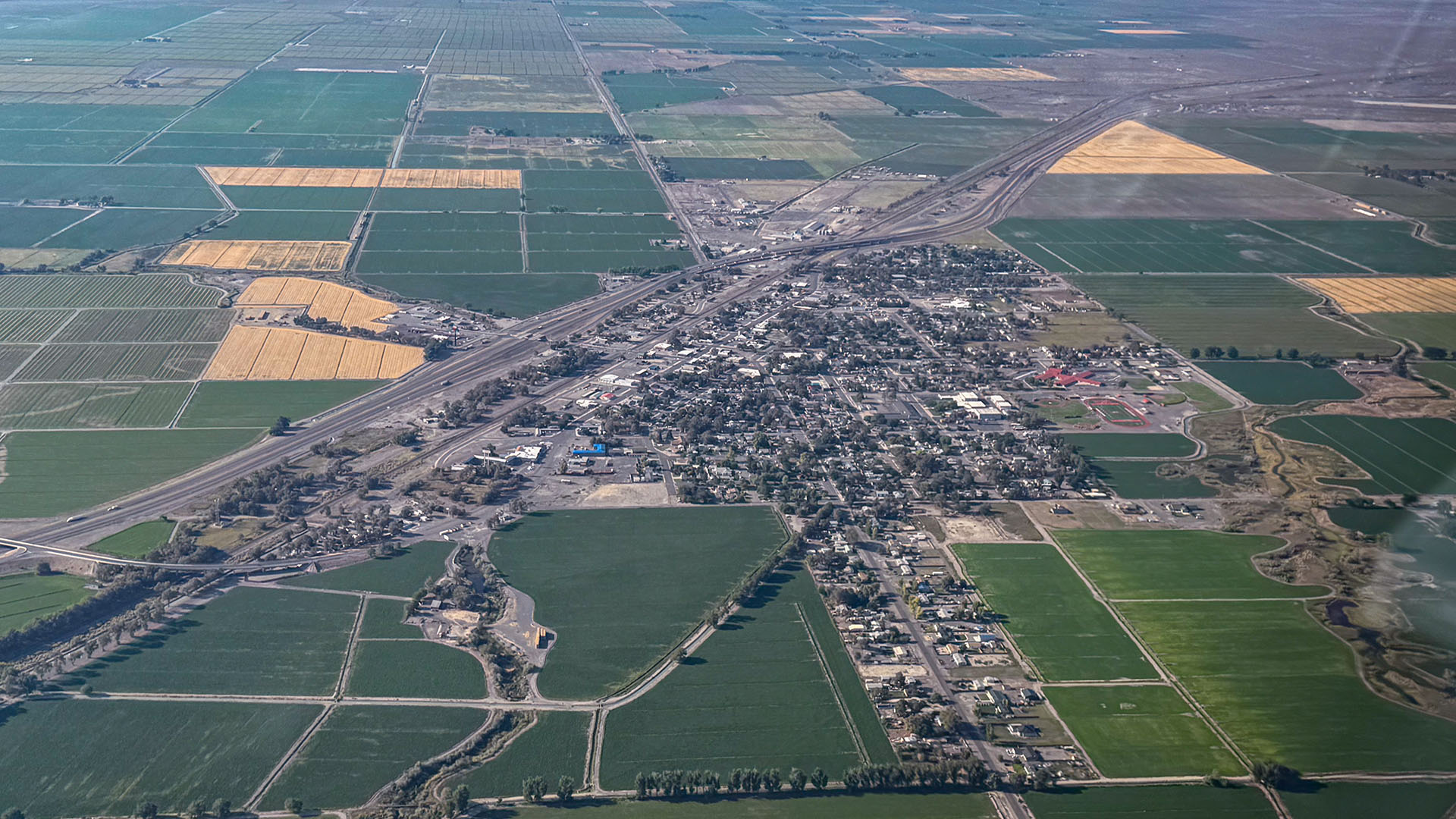 Aerial photo of Lovelock Nevada showing the town center, highways, and surrounding green farmland, highlighting a quiet small-town environment for massage and wellness services
