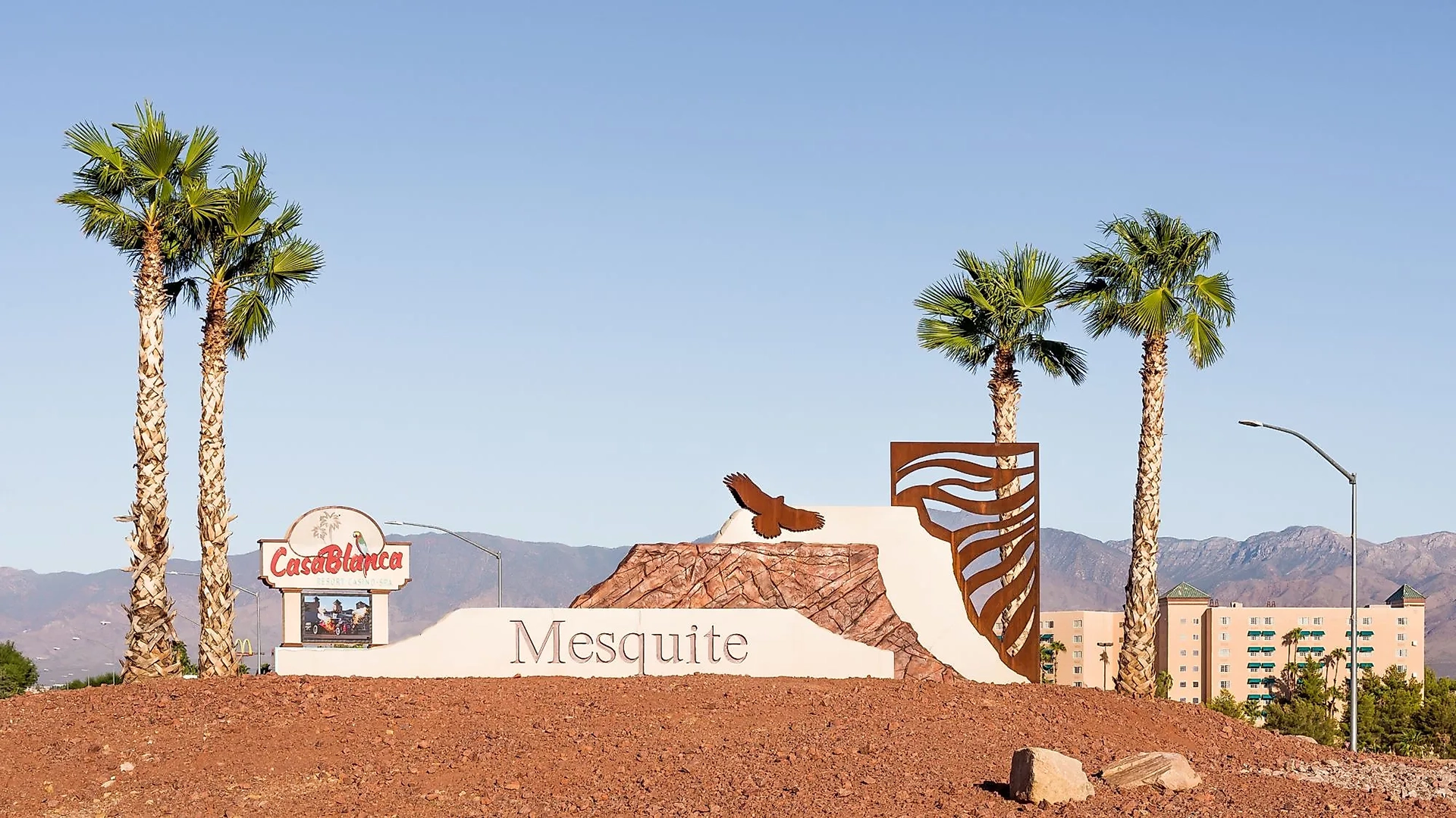 Welcome to Mesquite Nevada sign with palm trees, CasaBlanca Resort, and desert mountains, representing a relaxing destination for massage therapists and wellness seekers